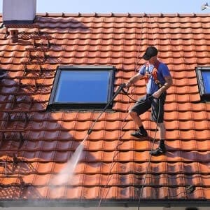 Contractor cleaning roof